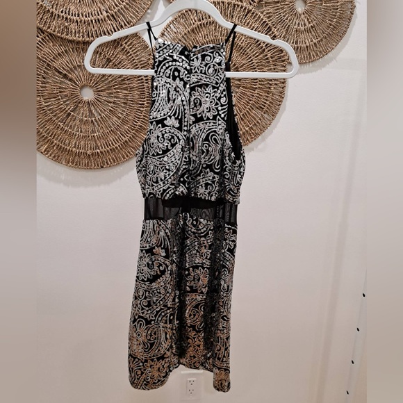 Black sequinned fitted mini dress with sheer panel at waist. - Picture 2 of 2